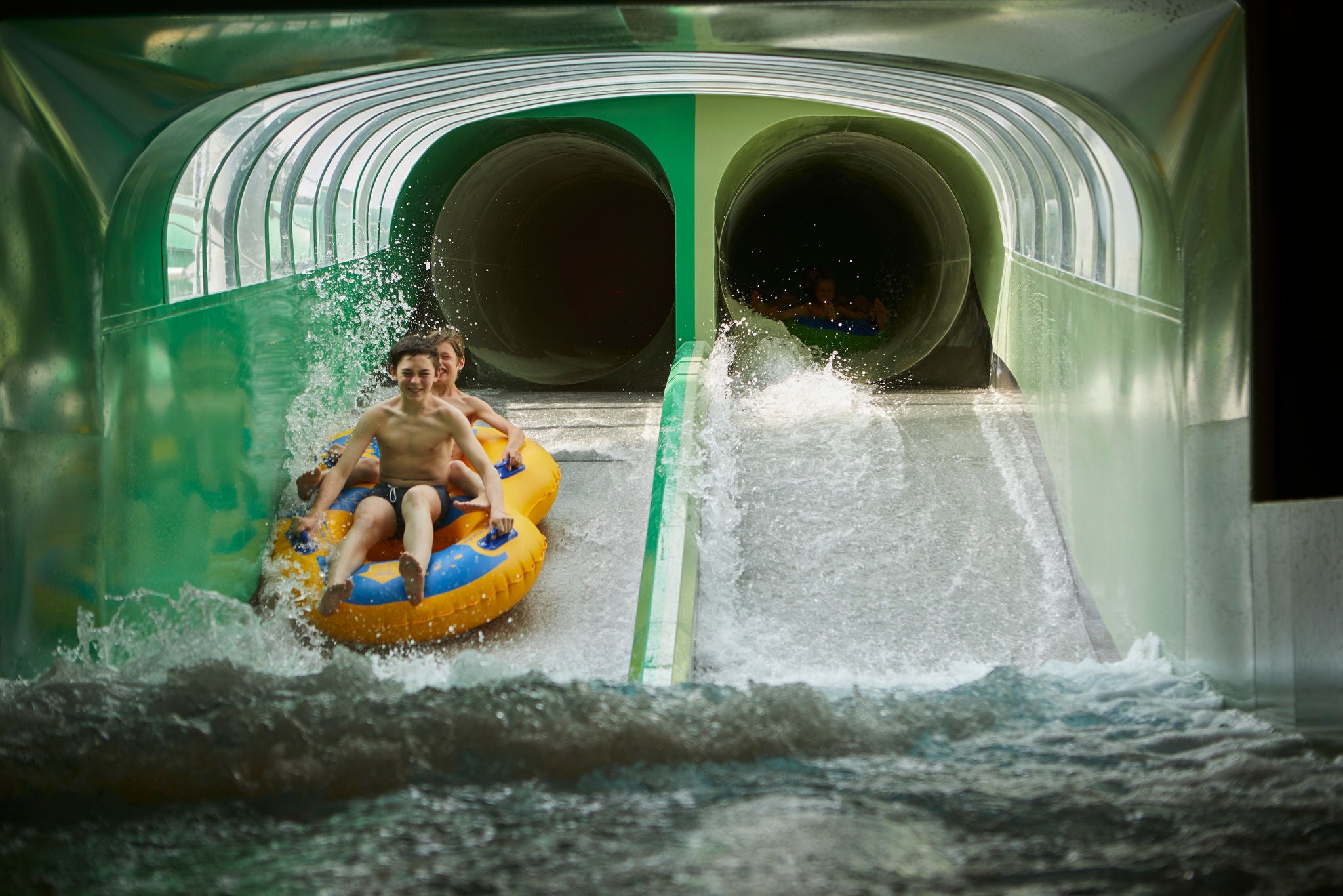 Jongens glijden samen in een band van de Splash Clash.