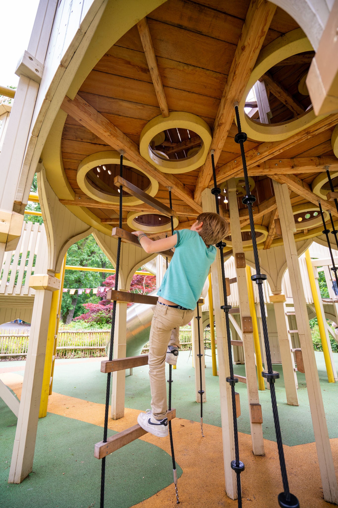 Jongen klimt omhoog op een trapladder van Hampi Playground.